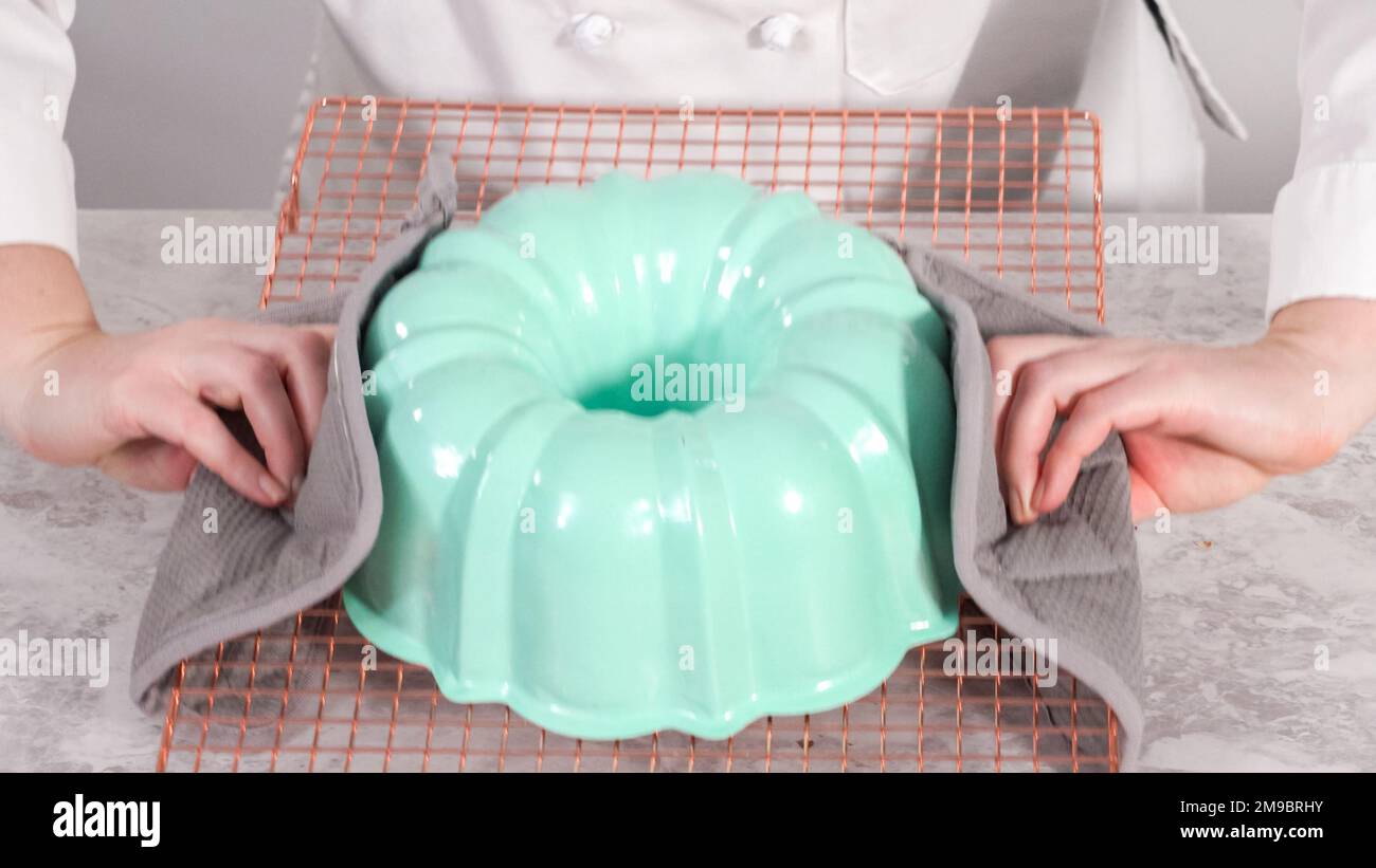 Step by step. Removing freshly baked funfettti bundt cake from the