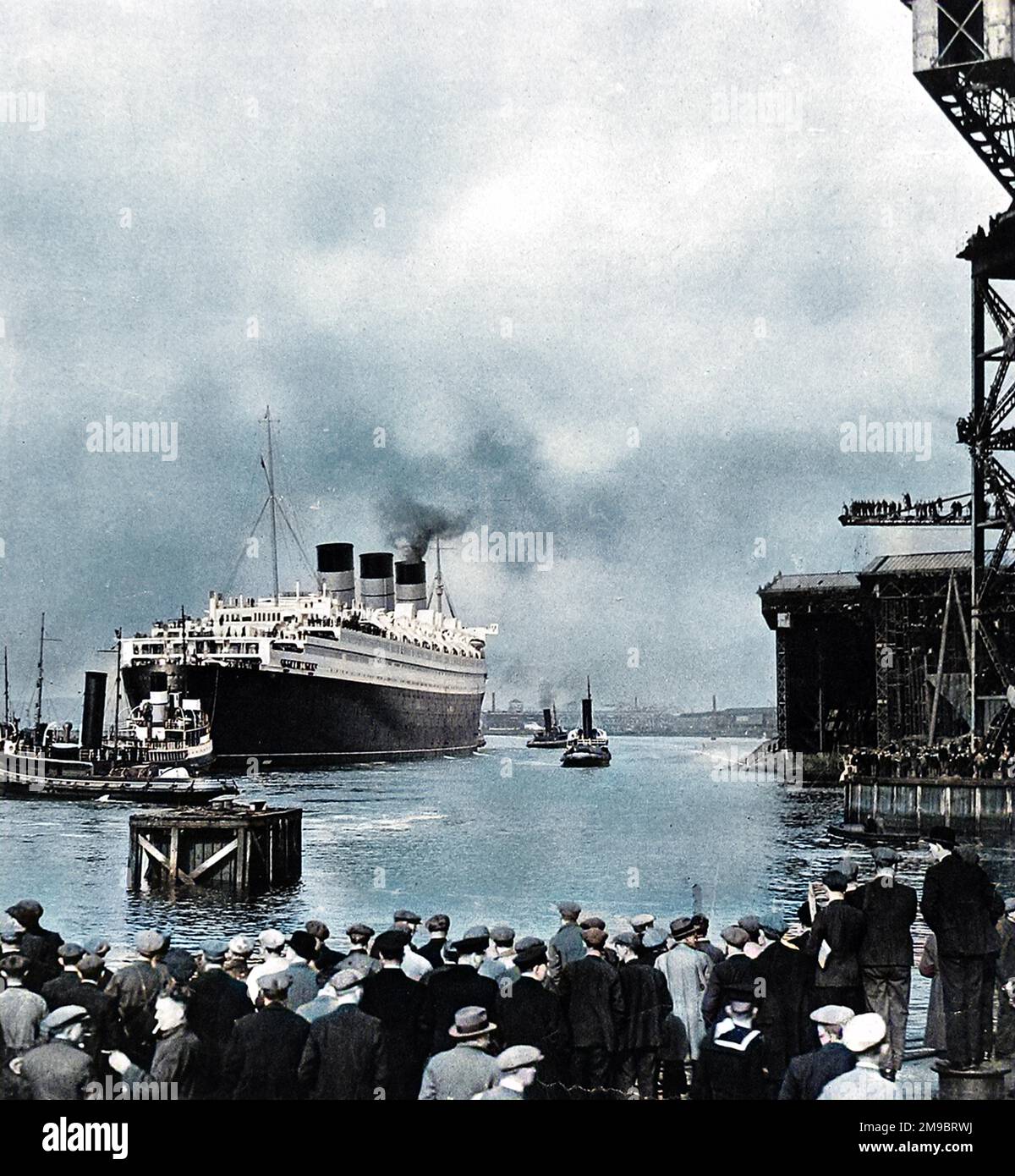Front cover of The Illustarted London News, showing a photograph of the R.M.S. 'Queen Mary' leaving John Brown's shipyard, Clydebank, for Greenock on 24th March 1936. Several of the seven tugs involved in manoevering the 'Queen Mary' down the Clyde are visible in the shot. Stock Photo