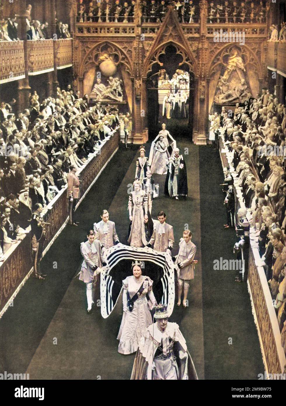 Queen Elizabeth, the Queen Mother passes along the nave of Westminster Abbey en route from the Annexe for the Coronation of her daughter, Queen Elizabeth II in June 1953.  She is followed by Princess Margaret and her retinue. Stock Photo