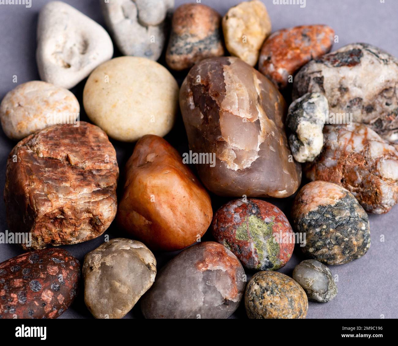 Each Stone A close-up of the natural stones, placed by each other on a mauve ...