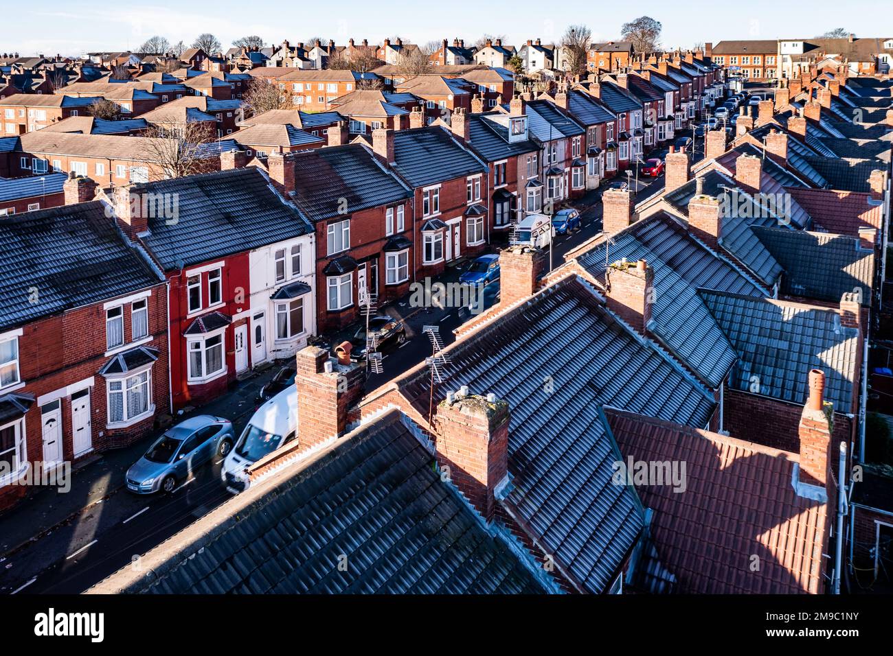 DONCASTER, UK - JANUARY 17, 2023.  Aerial view of a row of terraced or back to back houses during the Winter months with frost on rooftops during the Stock Photo