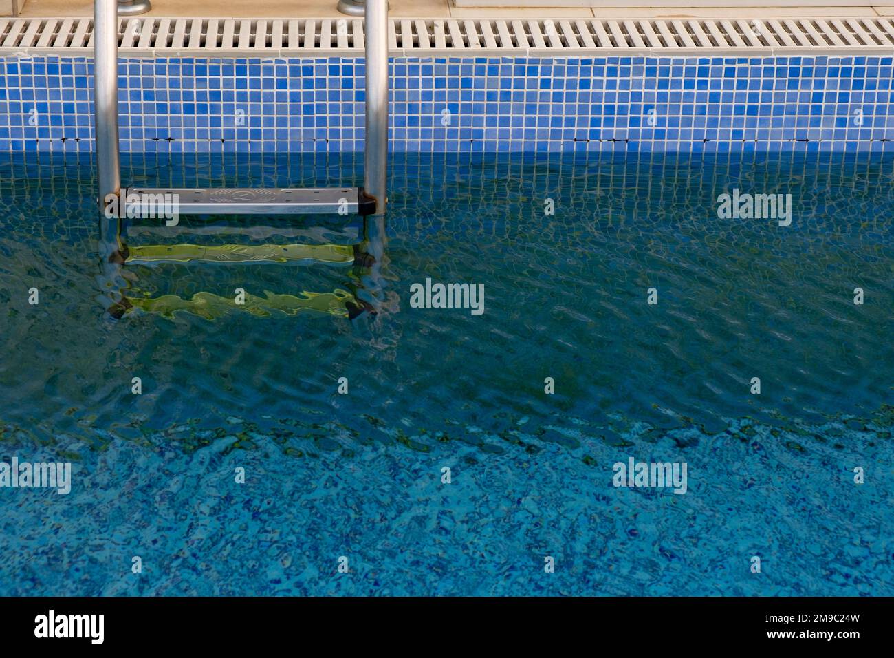 Swimming pool and ladder on a hotel appartment. Luxury vacations. Relaxing holidays Stock Photo