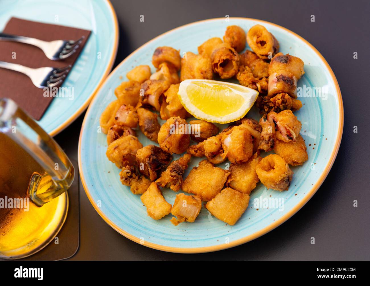 Spanish seafood dish battered fried baby squid Stock Photo Alamy