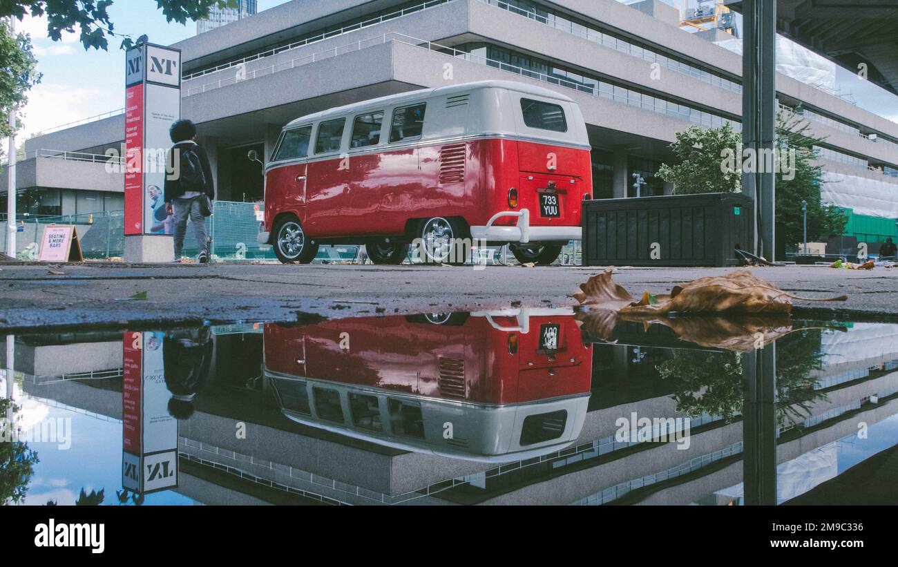 Puddle Van An old Volkswagen van in the streets of London with its reflection in ...