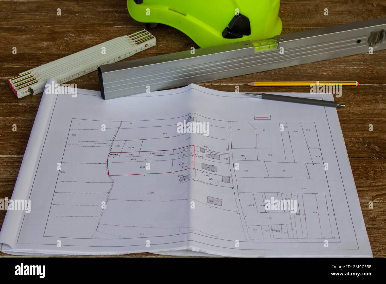 Image of a work table where plans for a building site are placed, a ...