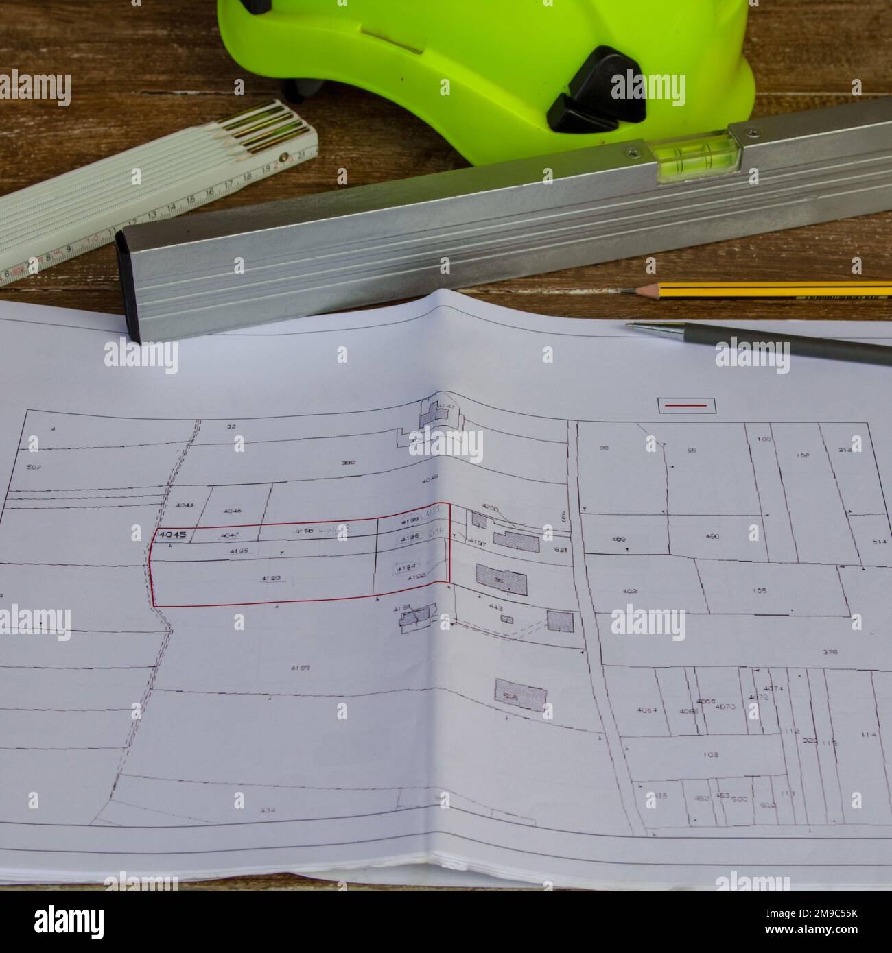 Image of a work table where plans for a building site are placed, a