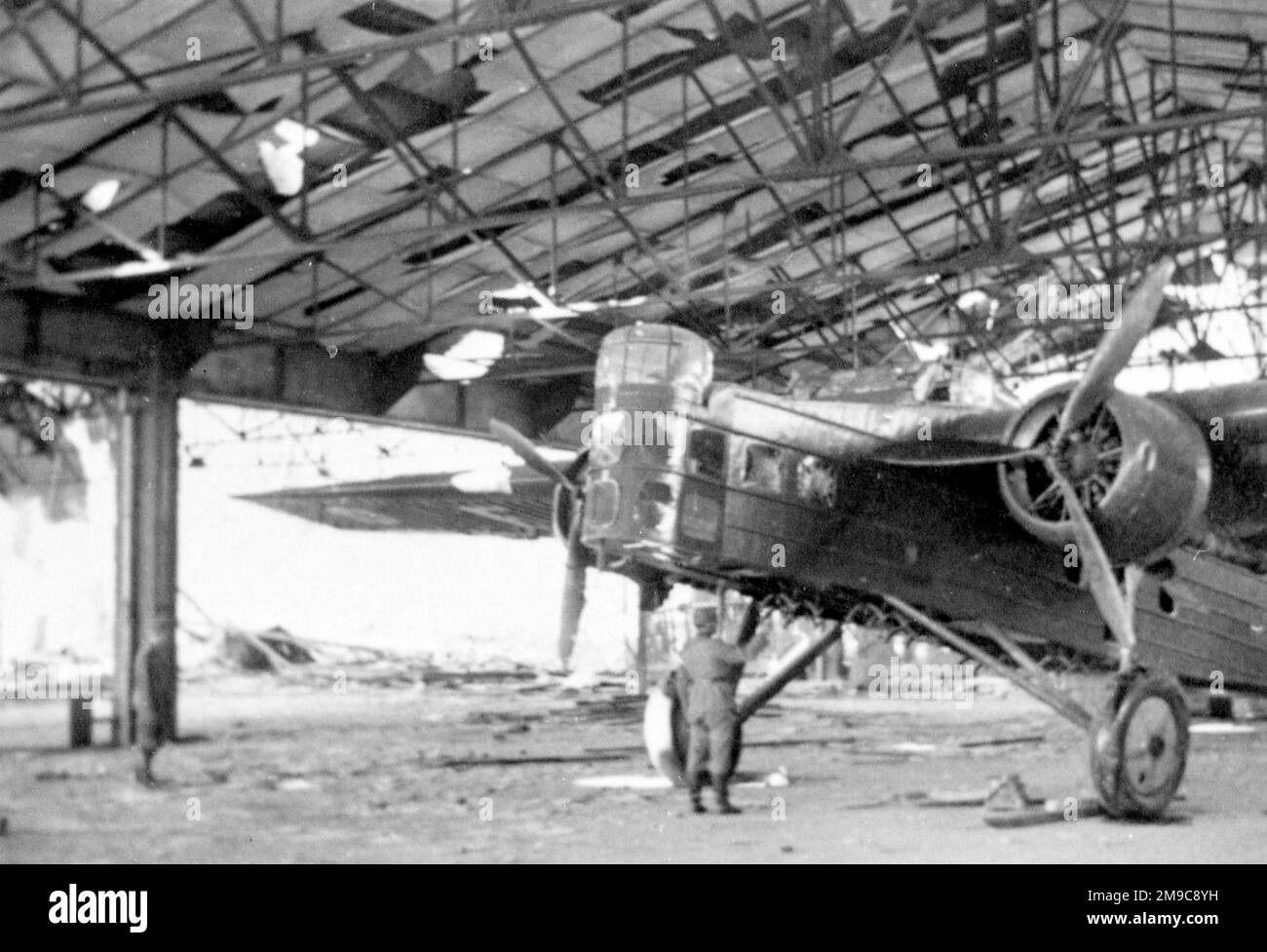 An abandoned Bloch MB.200, captured by German forces in a damaged hangar. Stock Photo