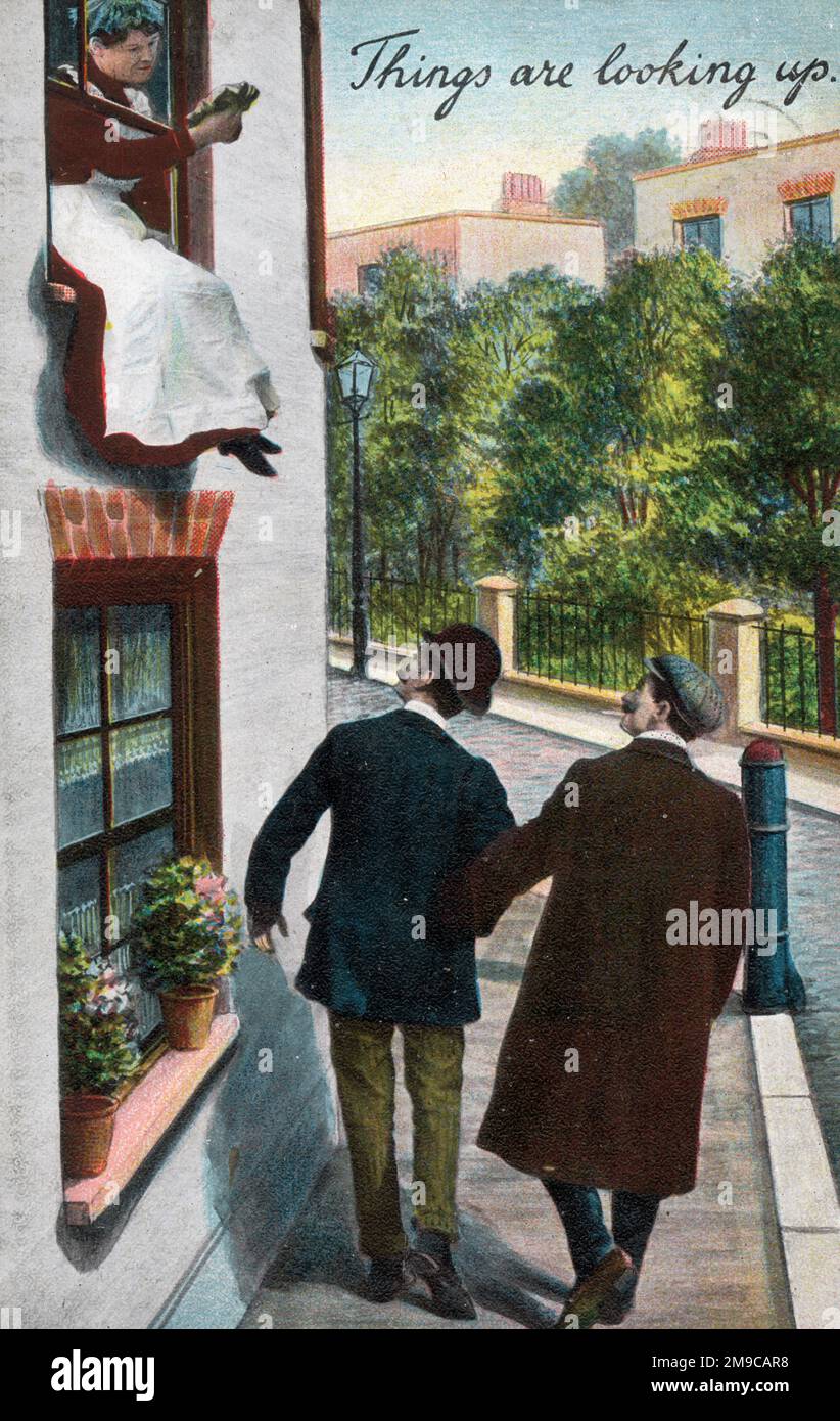 'Things are looking up' - two passing Gents are delighted to see their attentions have been spotted by a housemaid cleaning the upstairs windows of a streetside property Stock Photo