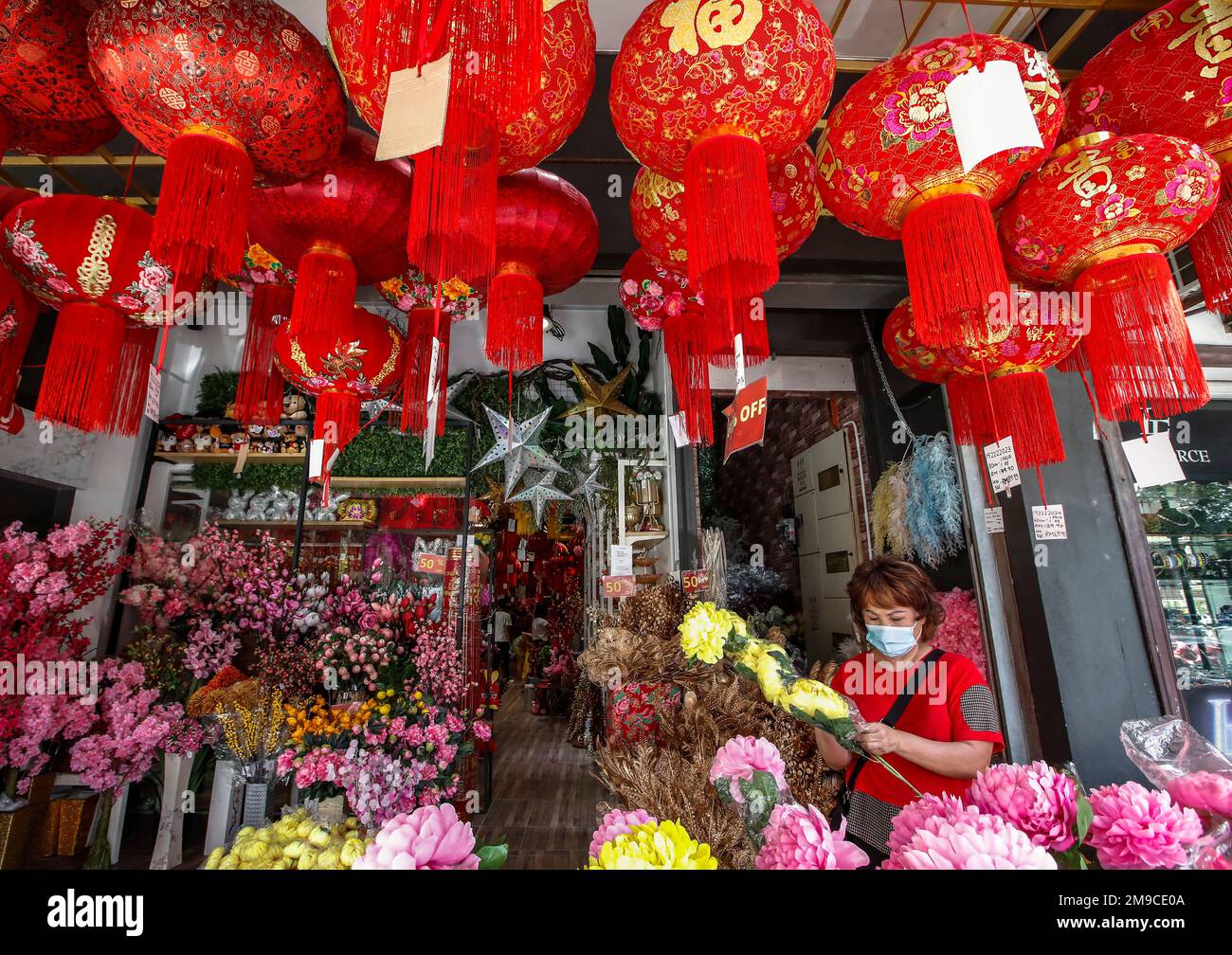 Kuala Lumpur, Malaysia. 17th Jan, 2023. An ethnic Chinese woman shops for  decorations near China town district ahead of the Lunar New Year of the  Rabbit. Lunar New Year which falls on