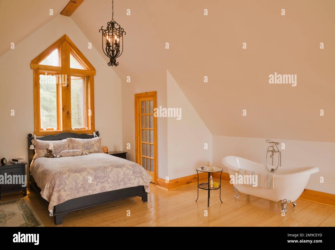 Queen size bed with wooden charcoal coloured headboard and footboard