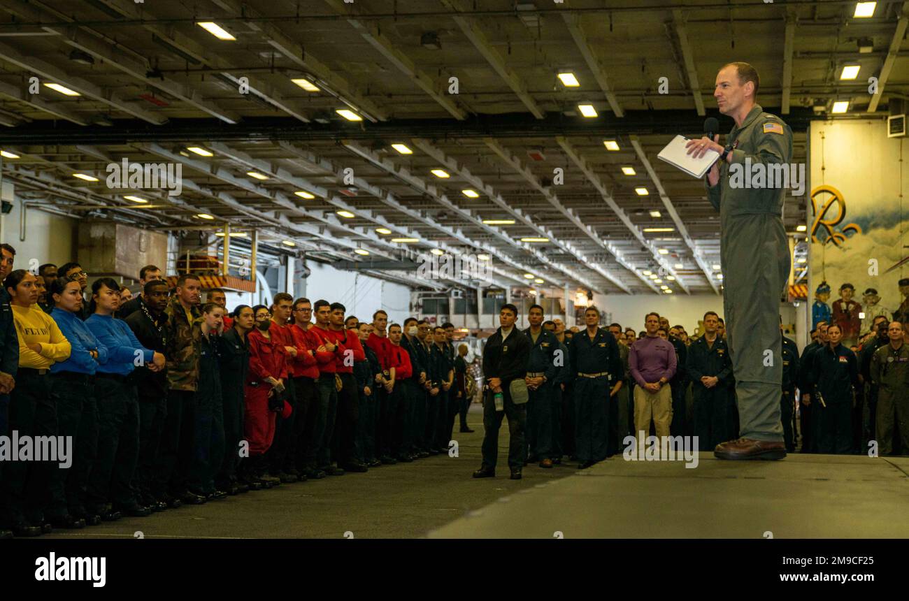 220516-N-DW158-1021 PACIFIC OCEAN (May 16, 2022) Capt. Justin Issler, executive officer of the U.S. Navy’s only forward-deployed aircraft carrier USS Ronald Reagan (CVN 76), speaks to Sailors during an all-hands call in the hangar bay. Ronald Reagan’s command team conducts all-hands calls to announce upcoming events, schedule changes, or important public service announcements to the ship’s crew. Ronald Reagan, the flagship of Carrier Strike Group 5, provides a combat-ready force that protects and defends the United States, and supports alliances, partnerships and collective maritime interests Stock Photo