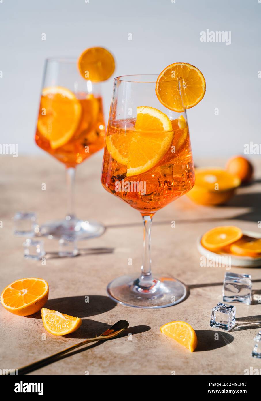 Close up of two aperol spritz drinks on sunny beige background. Stock Photo