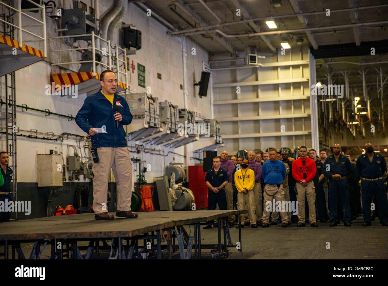 220516-N-DW158-1043 PACIFIC OCEAN (May 16, 2022) Capt. Fred Goldhammer, commanding officer of the U.S. Navy’s only forward-deployed aircraft carrier USS Ronald Reagan (CVN 76), speaks to Sailors during an all-hands call in the hangar bay. Ronald Reagan’s command team conducts all-hands calls to announce upcoming events, schedule changes, or important public service announcements to the ship’s crew. Ronald Reagan, the flagship of Carrier Strike Group 5, provides a combat-ready force that protects and defends the United States, and supports alliances, partnerships and collective maritime interes Stock Photo