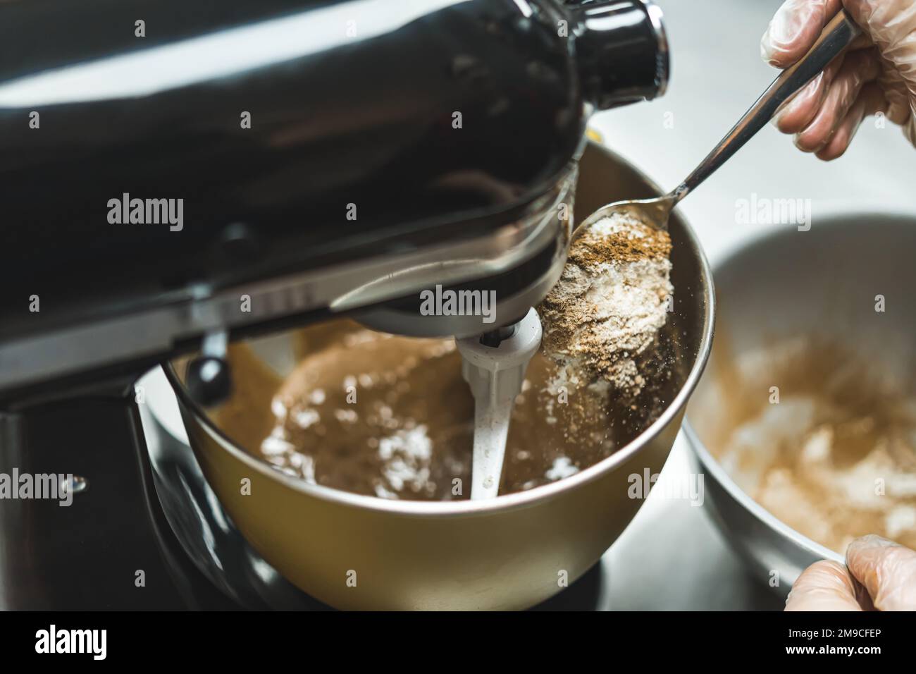 Woman baking chocolate cup cakes in glass tray in kitchen closeup. Young  girl put muffins in hot over. Female cooking tasty snack pastry at home.  Hea Stock Photo - Alamy