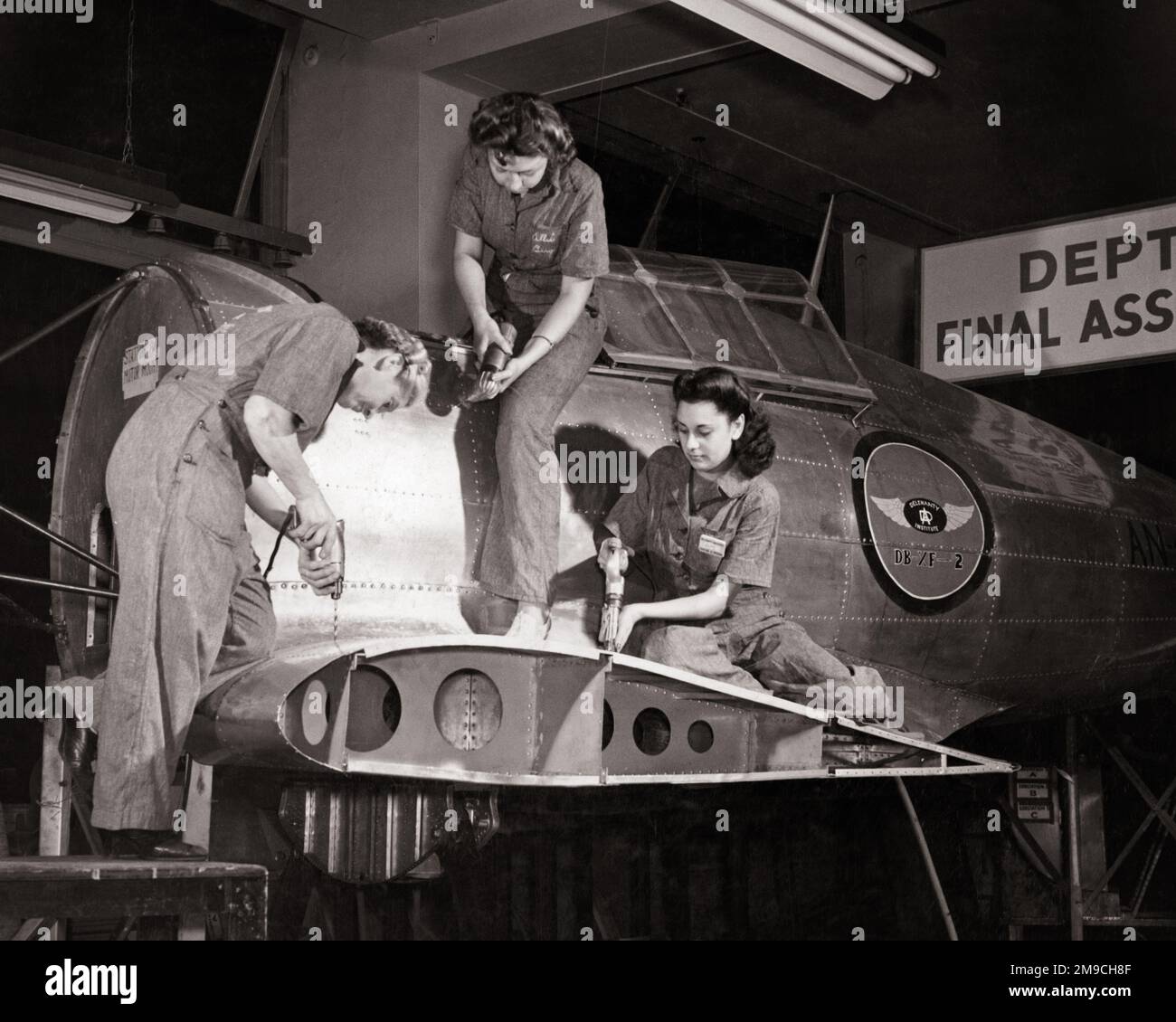 1940s THREE YOUNG WOMEN IN TRAINING FOR WARTIME JOBS WORKING ON AIRPLANES IN DEFENSE FACTORIES DURING WW2 NYC USA - q42295 CPC001 HARS PERSONS INSPIRATION CONFIDENCE B&W GOALS SKILL OCCUPATION SKILLS ADVENTURE AIRPLANES LOW ANGLE PROGRESS WORLD WARS LABOR PRIDE WORLD WAR WORLD WAR TWO WORLD WAR II OPPORTUNITY EMPLOYMENT NYC OCCUPATIONS WARTIME SUPPORT WORLD WAR 2 EMPLOYEE DEFENSE RIVET TOGETHERNESS YOUNG ADULT WOMAN BLACK AND WHITE CIVILIAN FACTORIES LABORING OLD FASHIONED Stock Photo