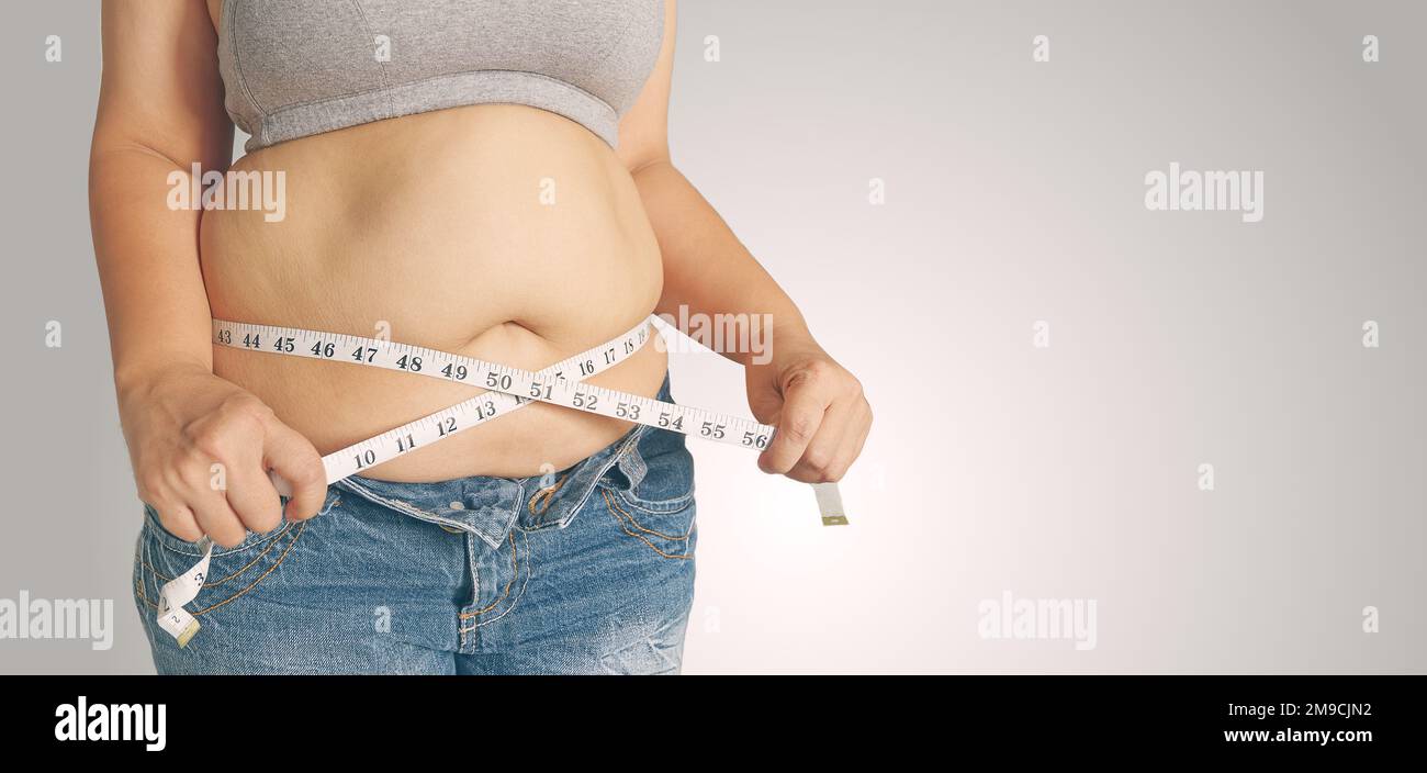 https://c8.alamy.com/comp/2M9CJN2/fat-woman-holding-a-measurement-tapebody-fat-percentage-with-measuring-tape-for-fat-2M9CJN2.jpg