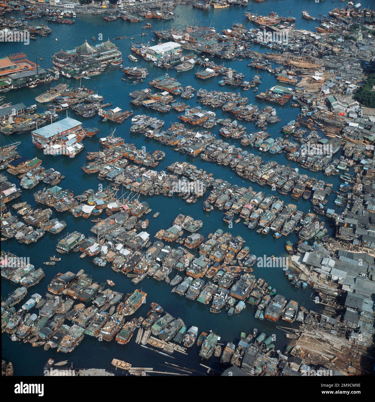 20,000 people lived in  fishing junks in Aberdeen Harbour before they were forced to move into apartments. In 2001, 6,000 people still live in boats. Stock Photo