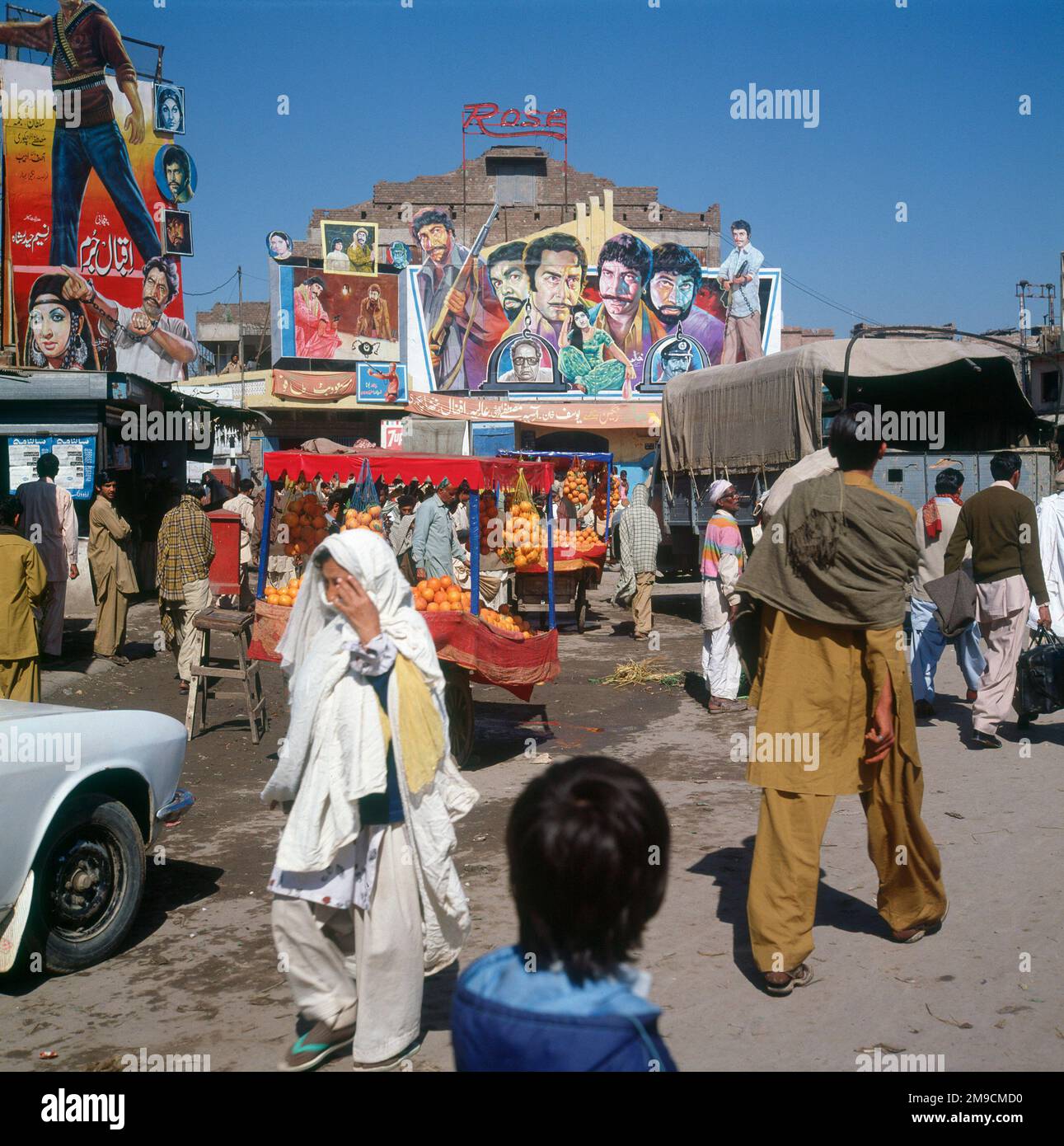 A street scene with some brightly coloured cinema posters in the background. Stock Photo