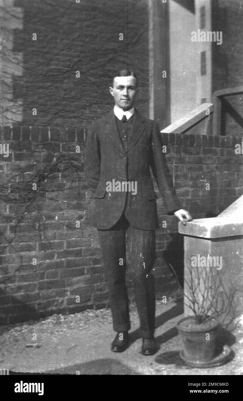 A young man standing in front of a brick wall in Southsea, England ...