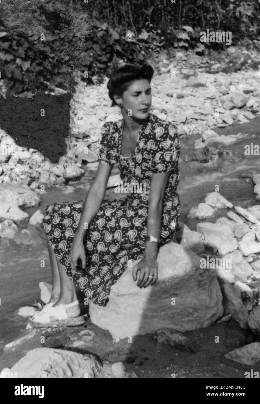 Woman sitting on rocks Black and White Stock Photos & Images - Alamy