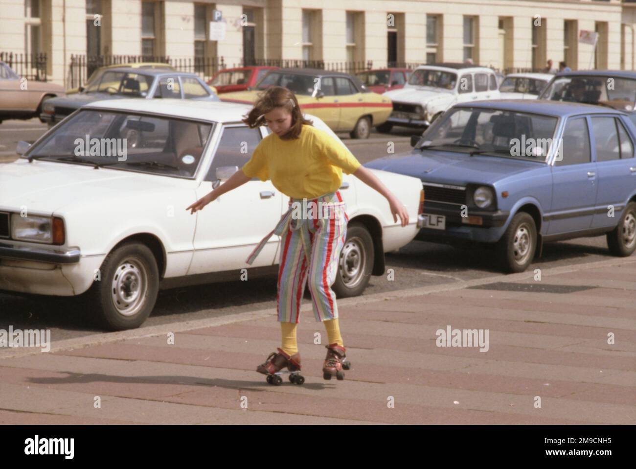 A girl rollerskating on the pavement at Brighton Stock Photo Alamy