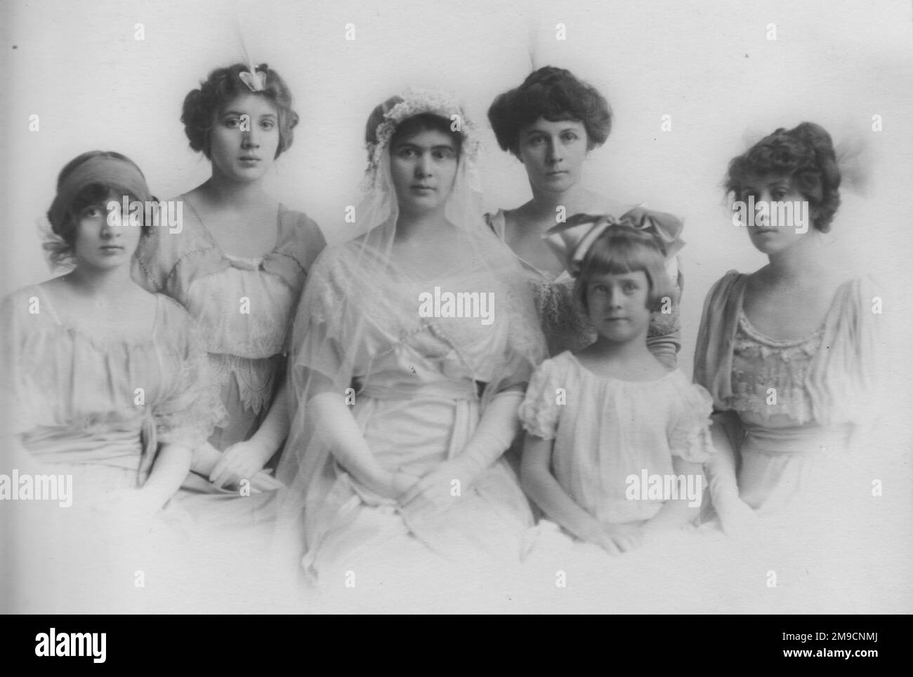 A young woman in her bridal costume, with her five sisters. They live in Vicksburg, Mississippi