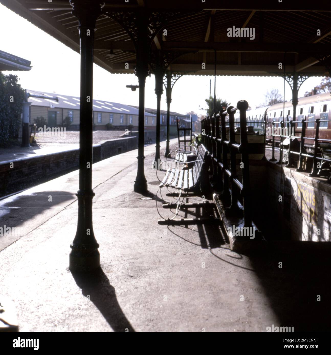 View on a desterted railway platform in Sussex on a sunny day. Stock Photo