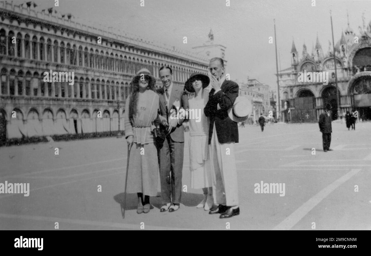 Four friends, two men and two women, pose for their photo in St Mark's Square, Venice. Stock Photo