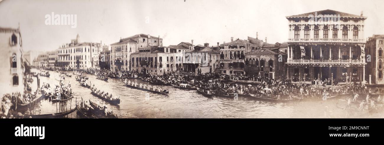View of the annual Venice Carnival in 1916, with people rowing on the canal. Stock Photo