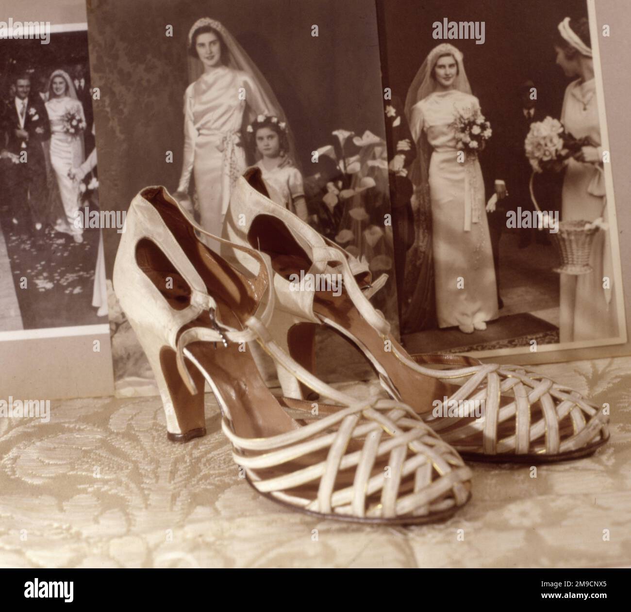 Wedding shoes and photographs dating from 1934. Stock Photo