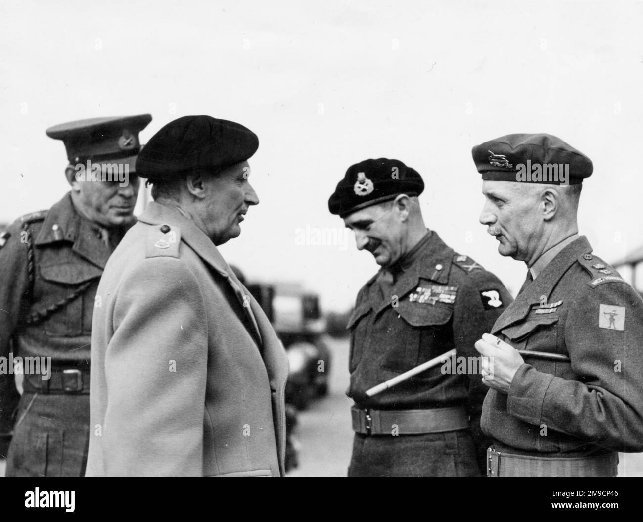 General Sir Montagu Stopford (1892-1971), Field Marshal Bernard Law Montgomery, 1st Viscount Montgomery of Alamein (1887-1976), and two other officers, probably during an inspection visit to an army camp. Stock Photo