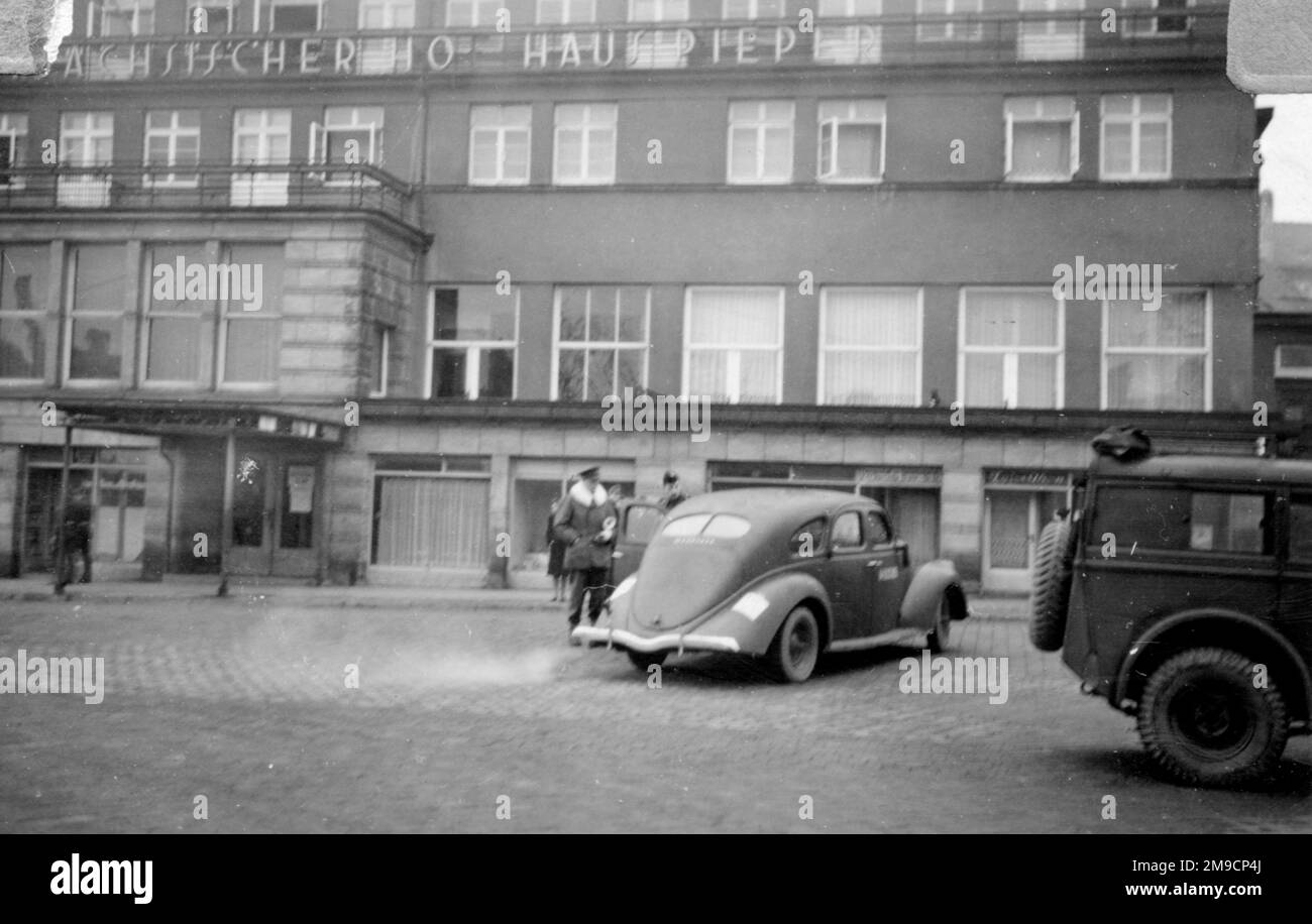 A British army officer about to get into a car outside an hotel, the Sachsischer Hof Haus Pieper, in an unidentified German town, at the end of the Second World War. Stock Photo