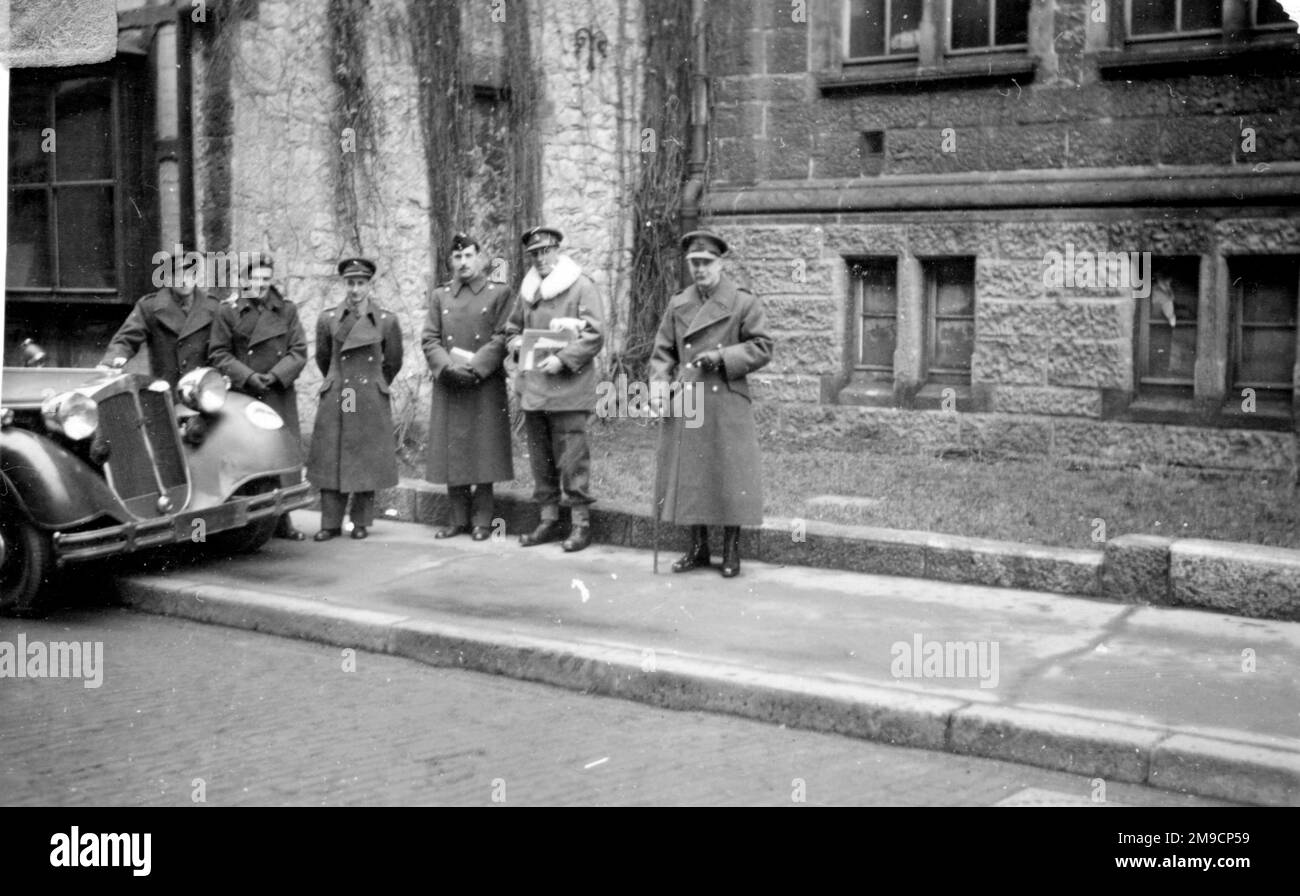 A group of six British army officers in an unidentified town in Germany towards the end of the Second World War, photographed in the street near the town hall. Stock Photo