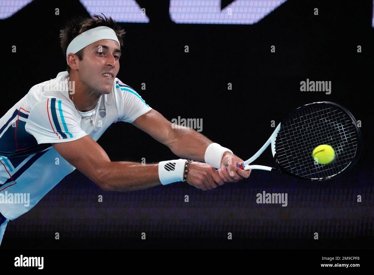 Tomas Martin Etcheverry of Argentina plays a backhand return to Jannik