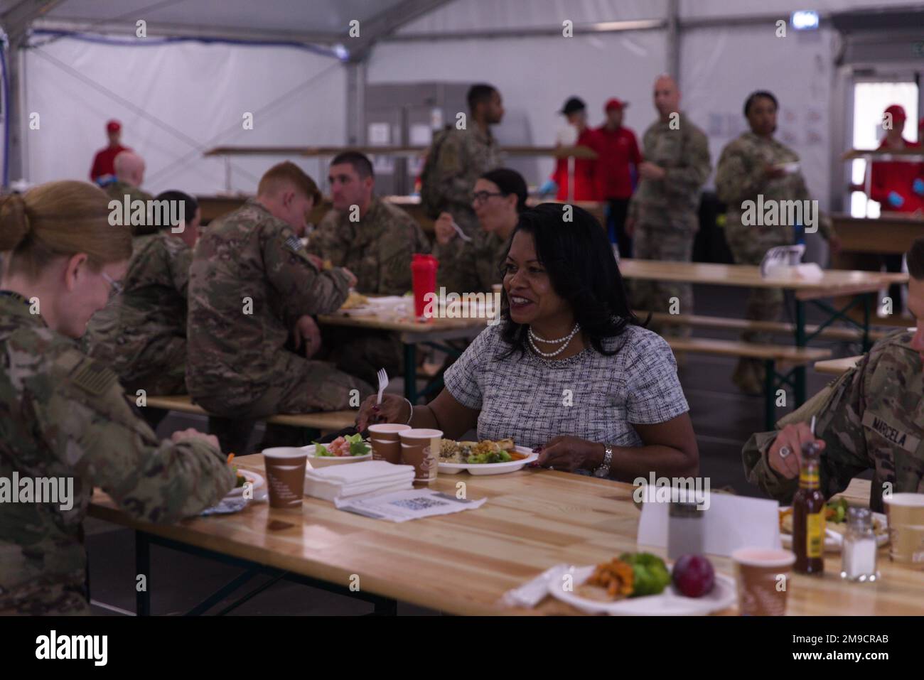 ANSBACH, Germany (May 17, 2022)- General Counsel of the Army, the Honorable Carrie F. Ricci, has lunch with V Corps Soldiers at the dining facility at U.S. Army Garrison Ansbach – Barton Barracks, Germany, Monday, May 16, 2022, during her tour of V Corps and USAG Ansbach. V Corps works alongside NATO allies and regional security partners to provide combat ready forces, execute joint and multinational training exercises to improve interoperability, and ensure an appropriate collective posture of deterrence and defense.. Stock Photo