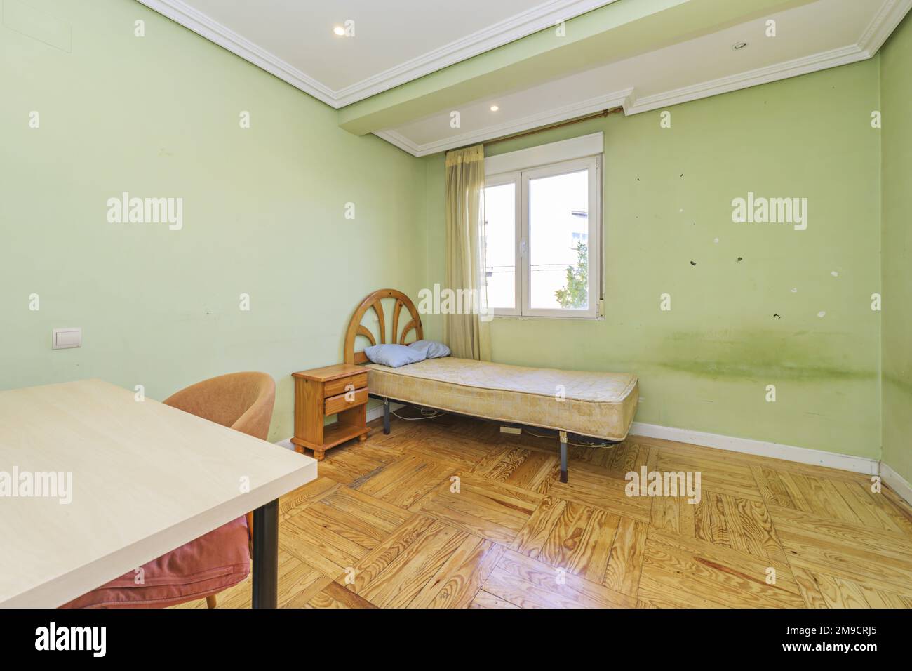 Old and dirty bedroom without sheets on the individual mattress Stock Photo