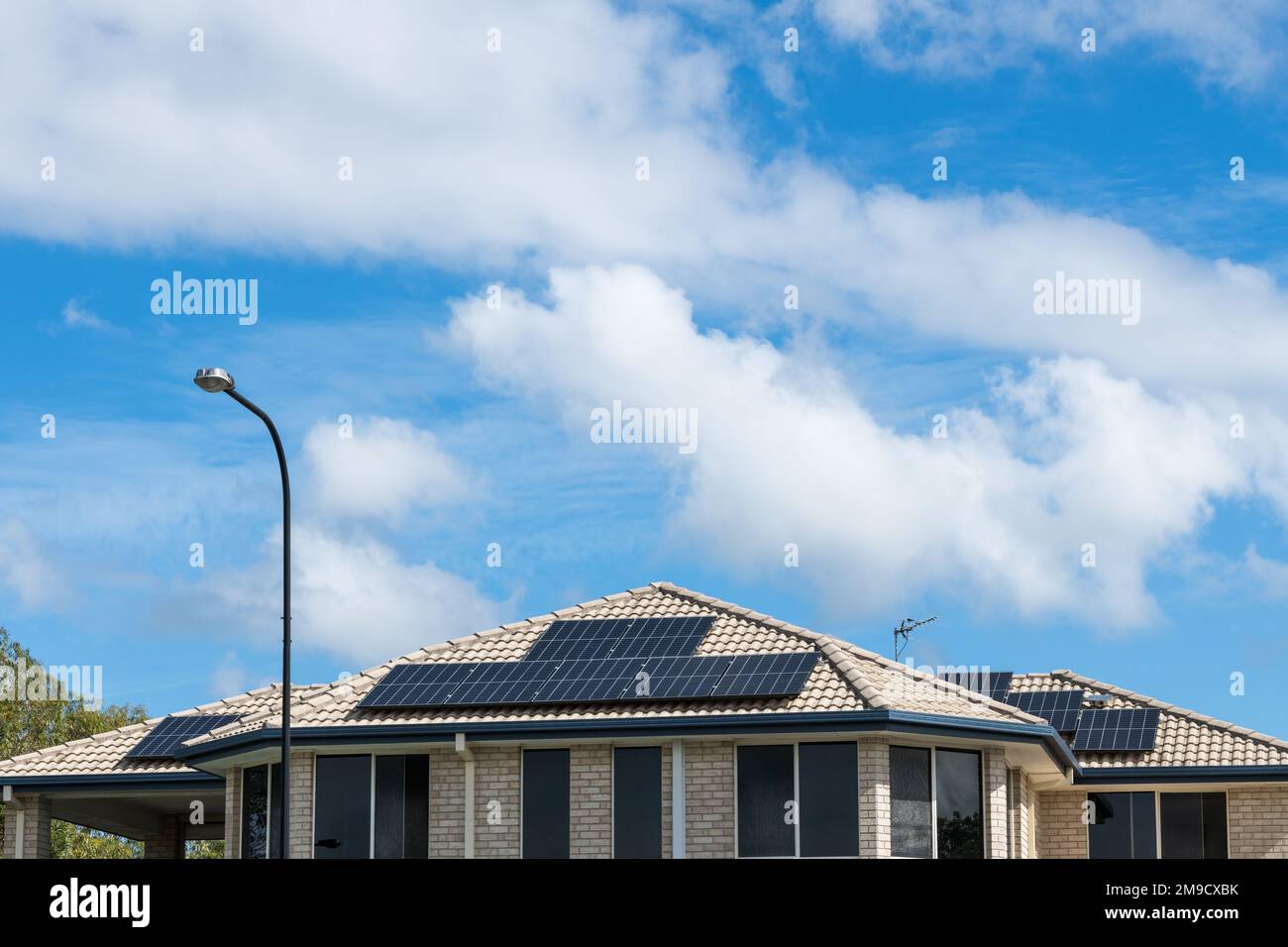 Solar panels on roof of home in Gold Coast, Australia, with copy space