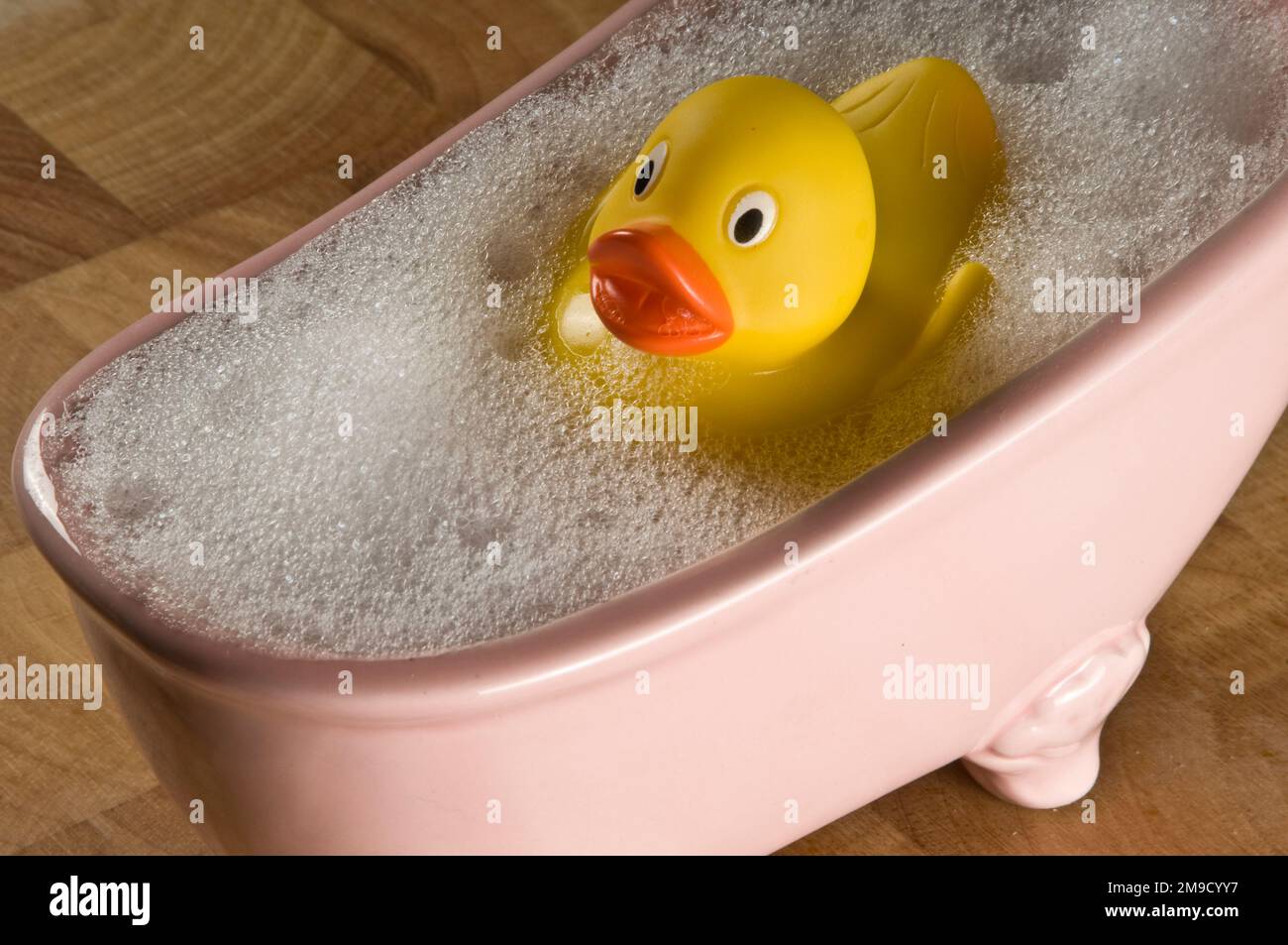 Rubber ducky in small pink porcelain bubble bath Stock Photo Alamy