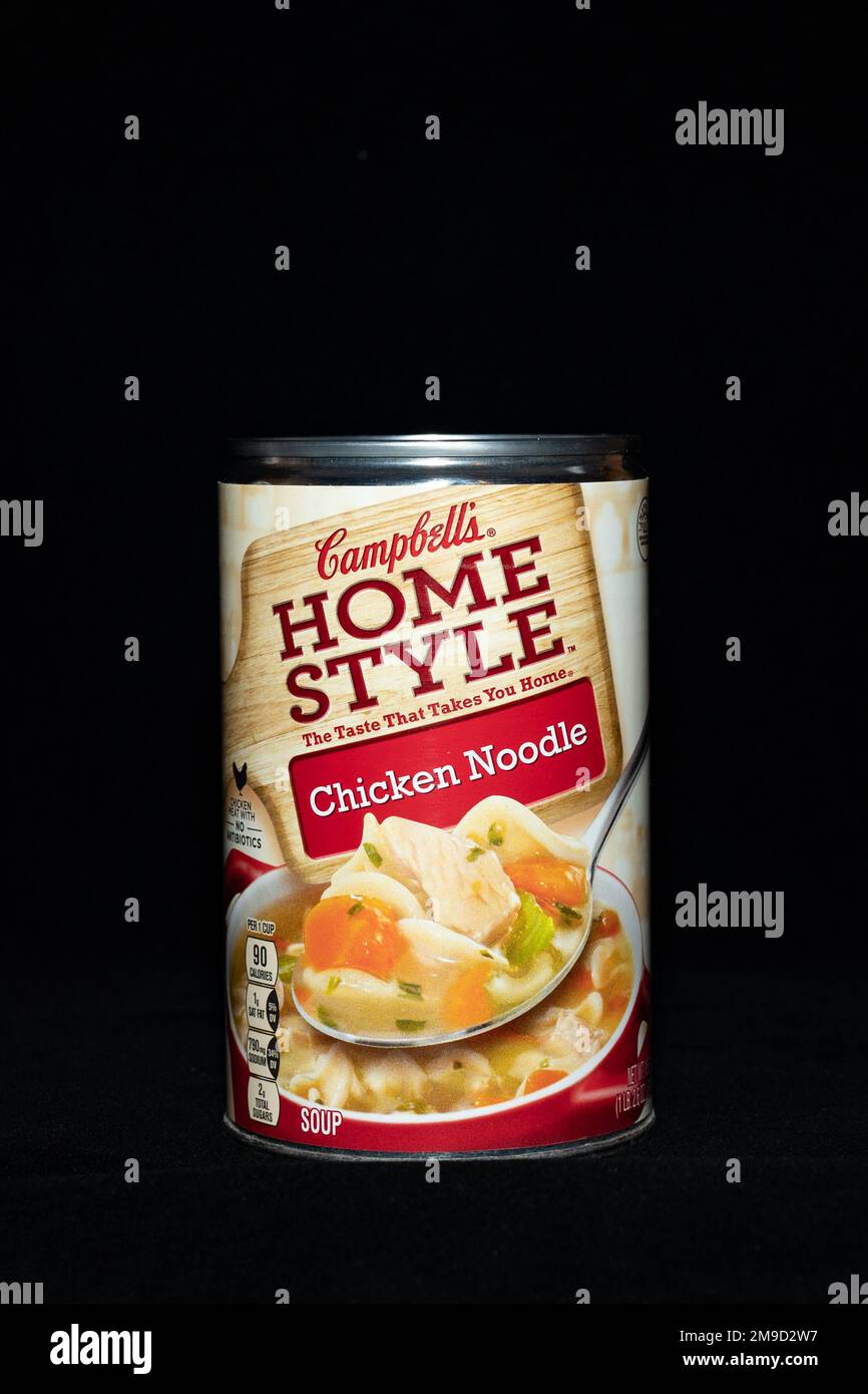 A can of Campbell's Home Style Chicken Noodle soup, a meal that just needs heating, isolated on black Stock Photo