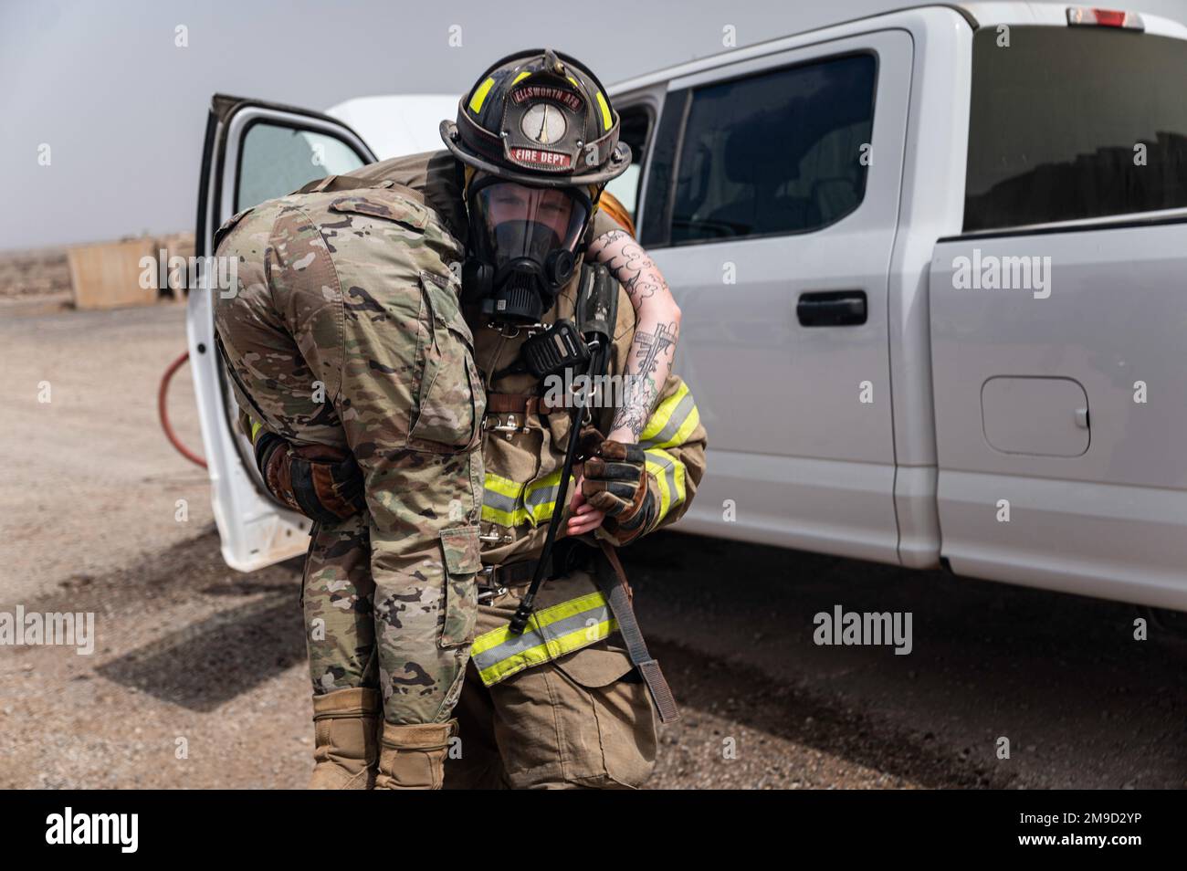 A U.S. Air Force fire protection specialist with the 776th Expeditionary Air Base Squadron (EABS) removes a simulated injured patient from a vehicle at Chabelley Airfield, Djibouti, May 16, 2022. The joint readiness training conducted by the 776th EABS and U.S. Army medics from the 2nd Squadron, 183rd Cavalry Regiment, served as their annual inspection where they responded to a simulated vehicle fire with injuries. Stock Photo