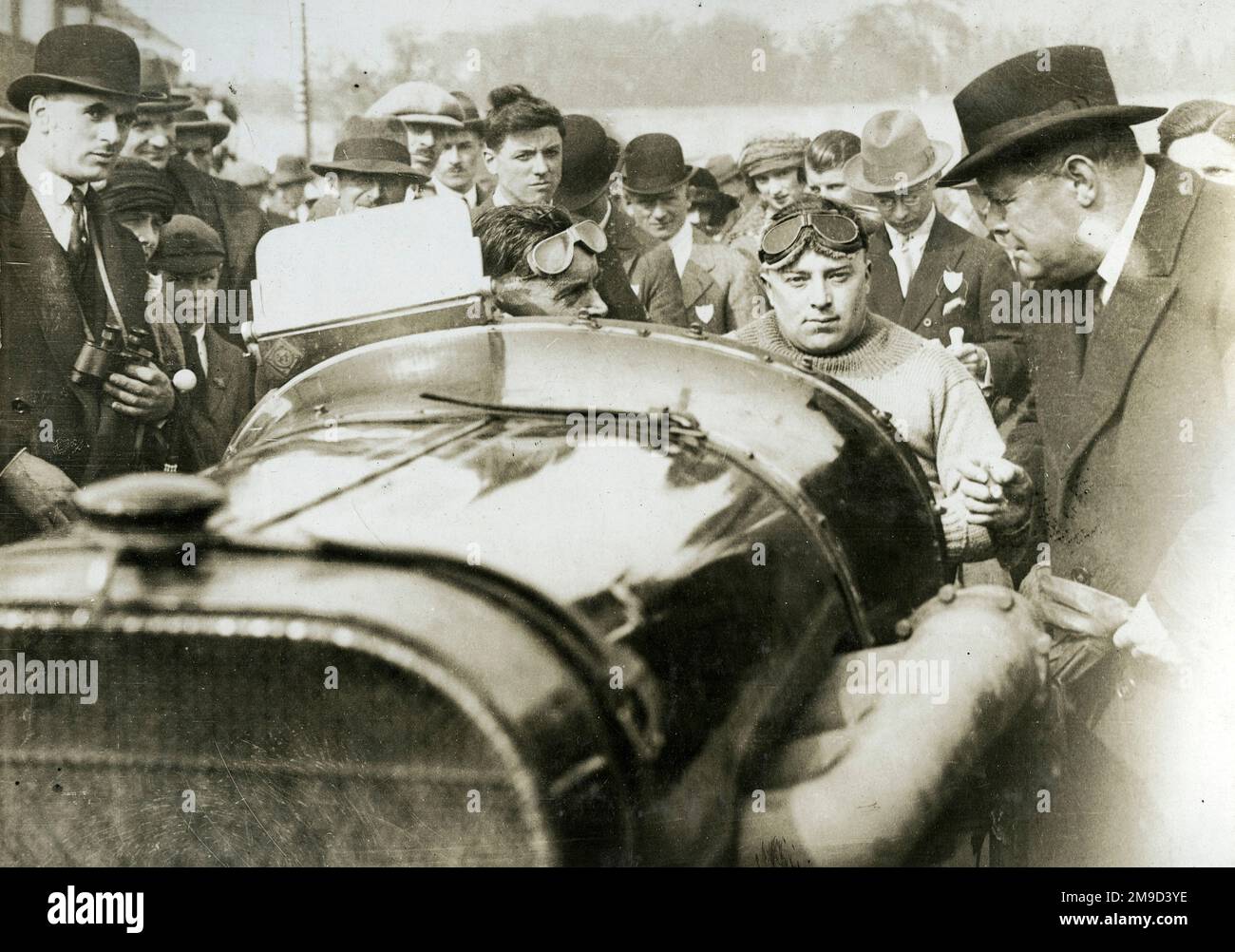 Sir Eric Geddes chairman of Dunlop inspecting Peugeot - Malcolm Campbell in car surrounded by crowds. Stock Photo