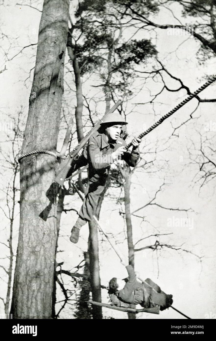 Belgian troops 'run' through the trees, WW2 Stock Photo