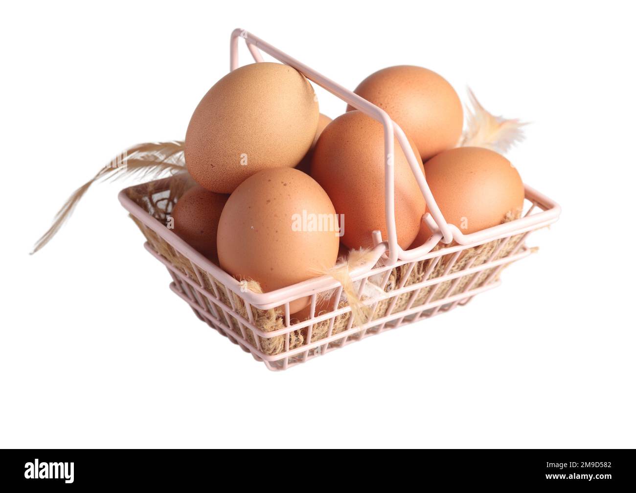 Raw chicken eggs in a basket on a white background Stock Photo