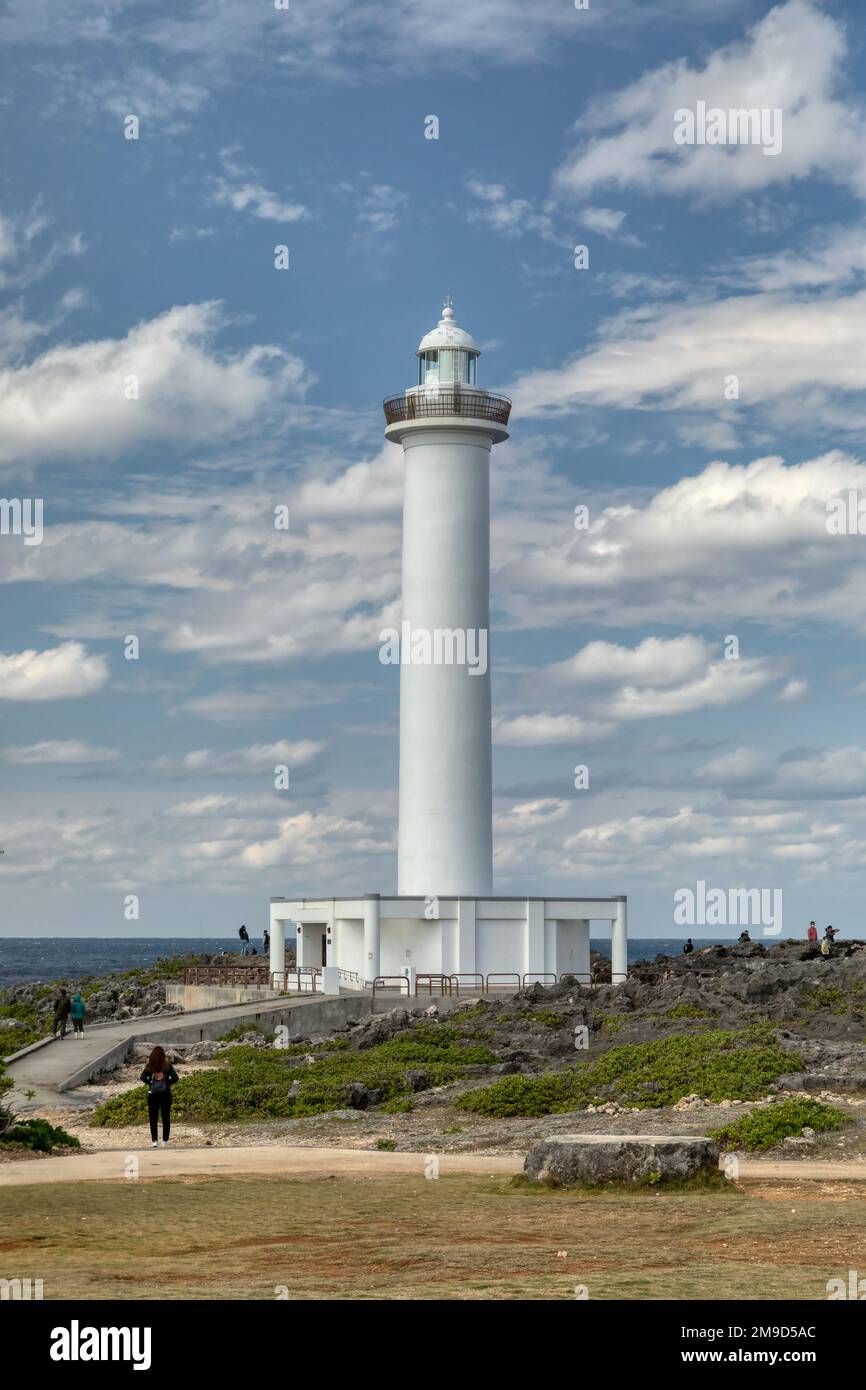 Tourists walk around the Cape Zanpa Lighthouse in Okinawa, Japan Stock Photo