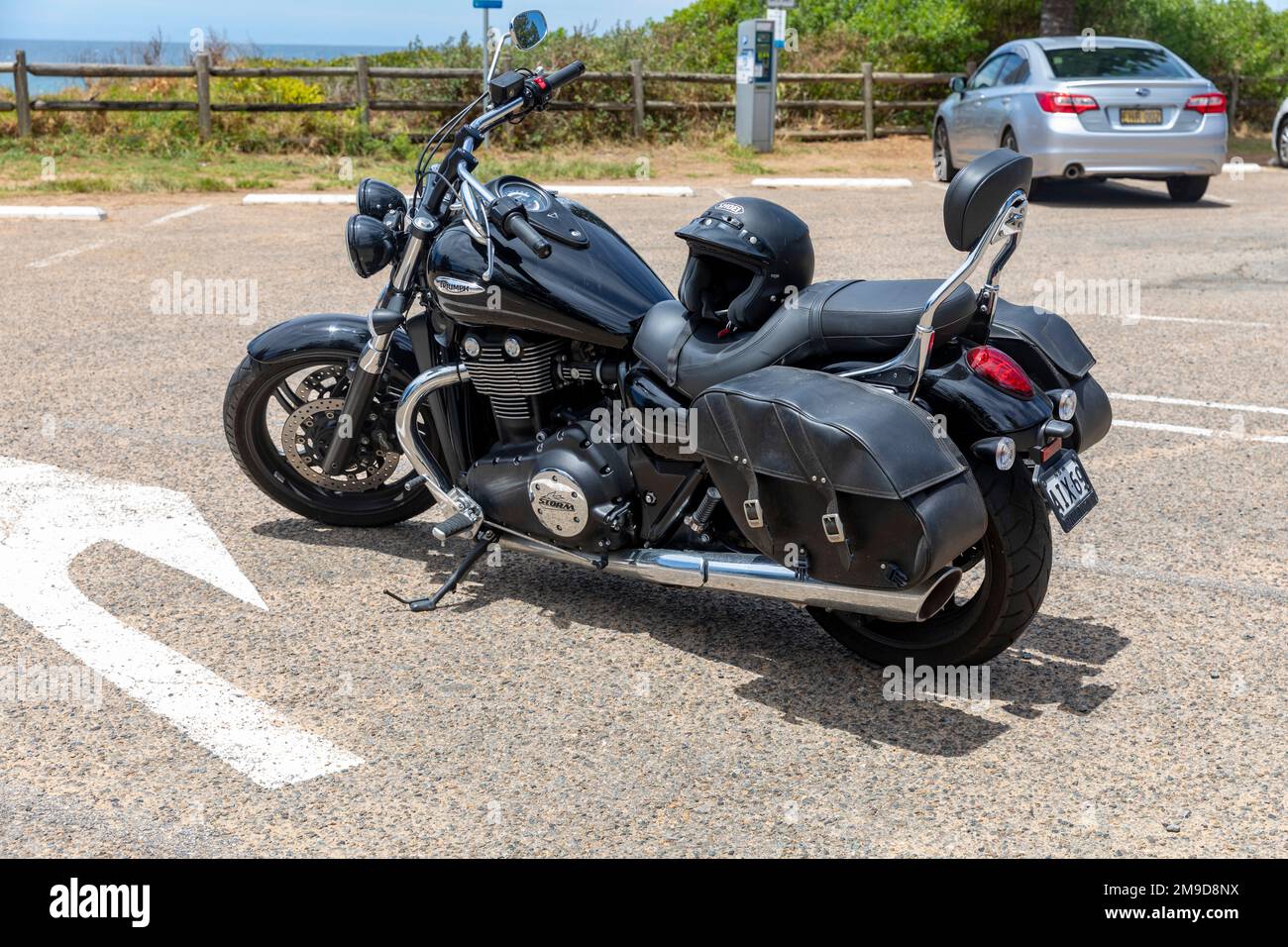 Black 2015 model Triumph Thunderbird storm parked by the beach in Newport Beach car parked, motorbike is property released,Sydney,Australia Stock Photo