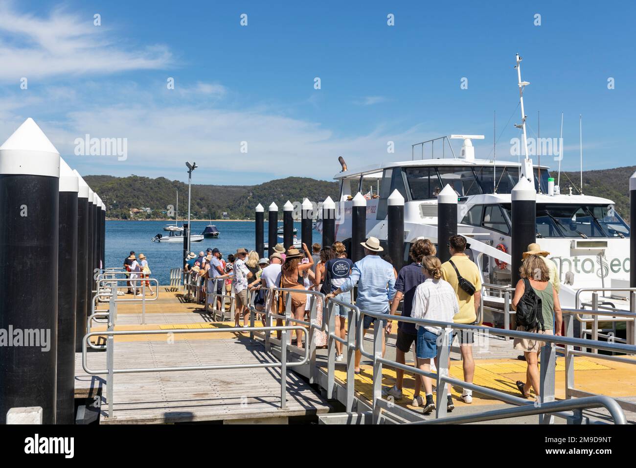 Holidaymakers and travellers at Palm Beach ferry wharf wait to board Fantasea ferry to Ettalong and Central Coast NSW, Pittwater,Sydney,Australia Stock Photo