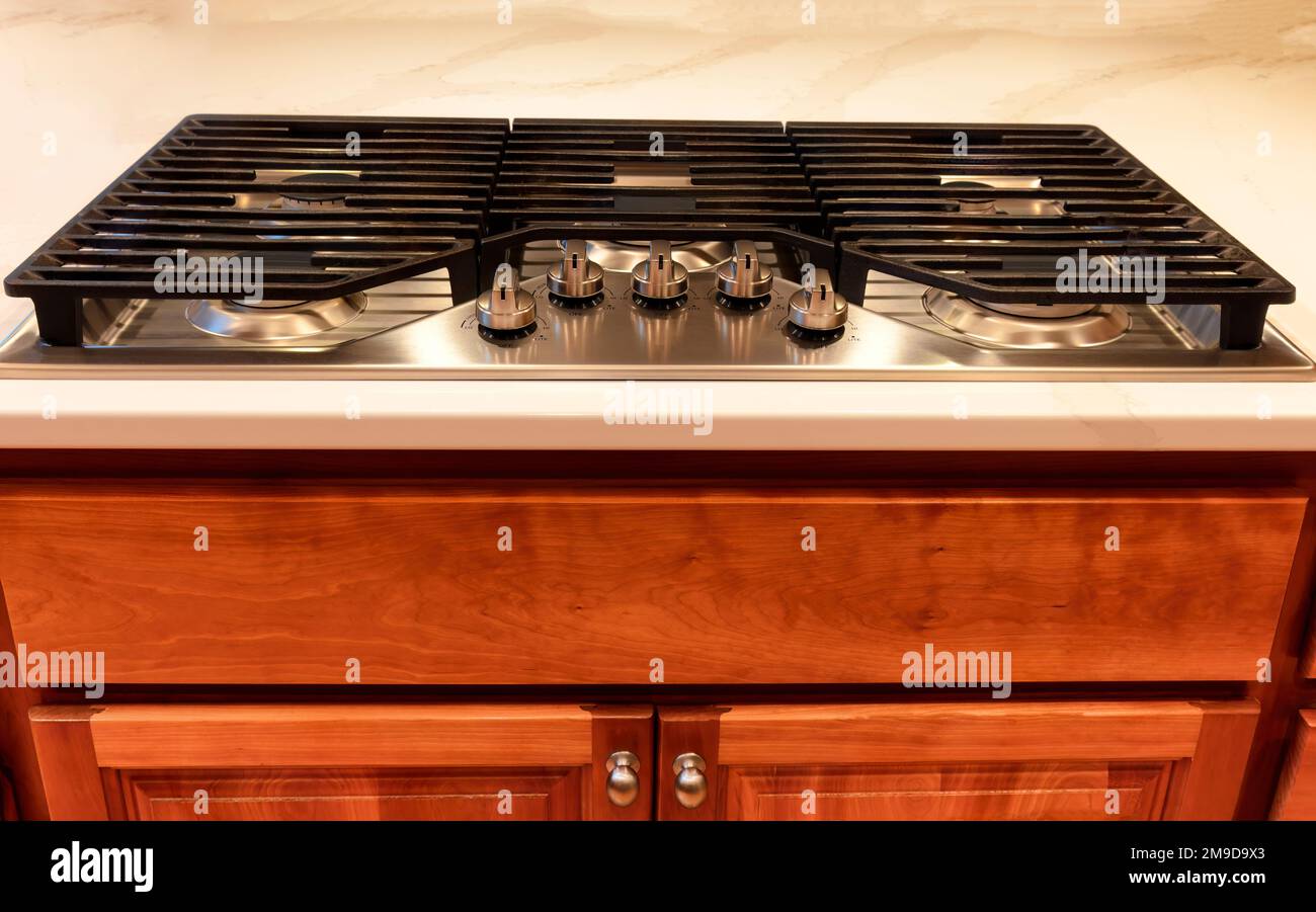 Front view of a modern natural gas Kitchen stove top cook surrounded by