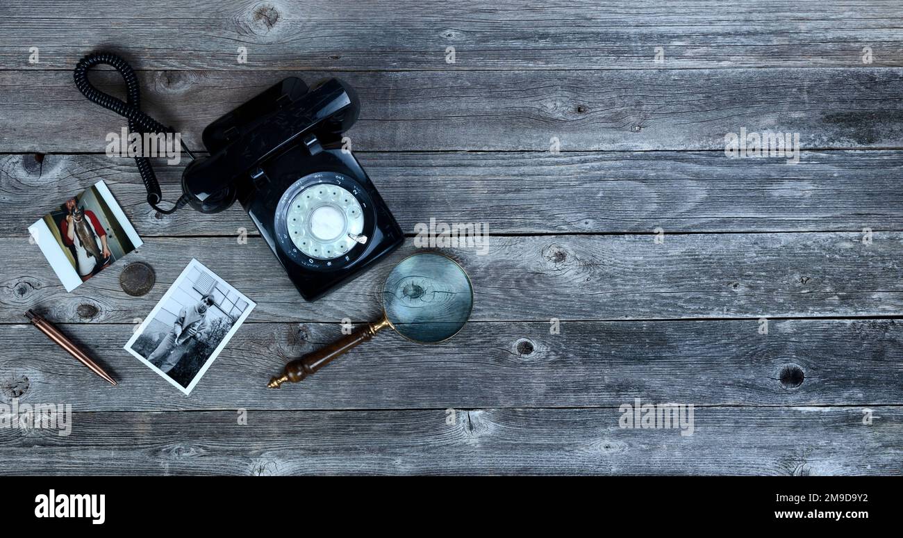 Old fishing photos and other antique items on vintage wooden table in flat lay view Stock Photo