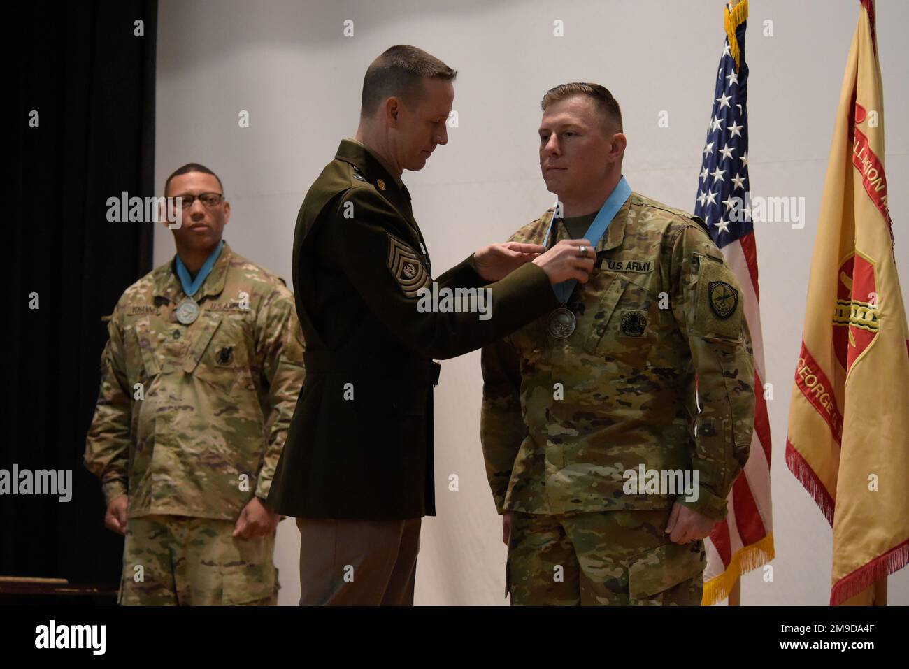 Command Sgt. Maj. Ronald Krause presents Sgt. 1st Class Andrea Collins