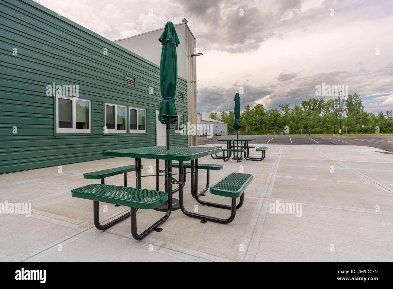 Picnic tables with umbrellas at a corporate office outdoor dining area